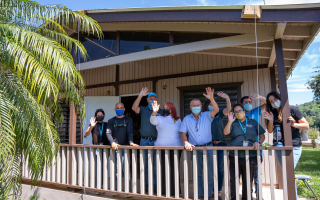  A group of people wave from the balcony, after a day of volunteering and celebration