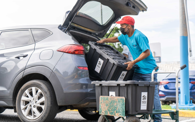 Persona descargando suministros de un carro